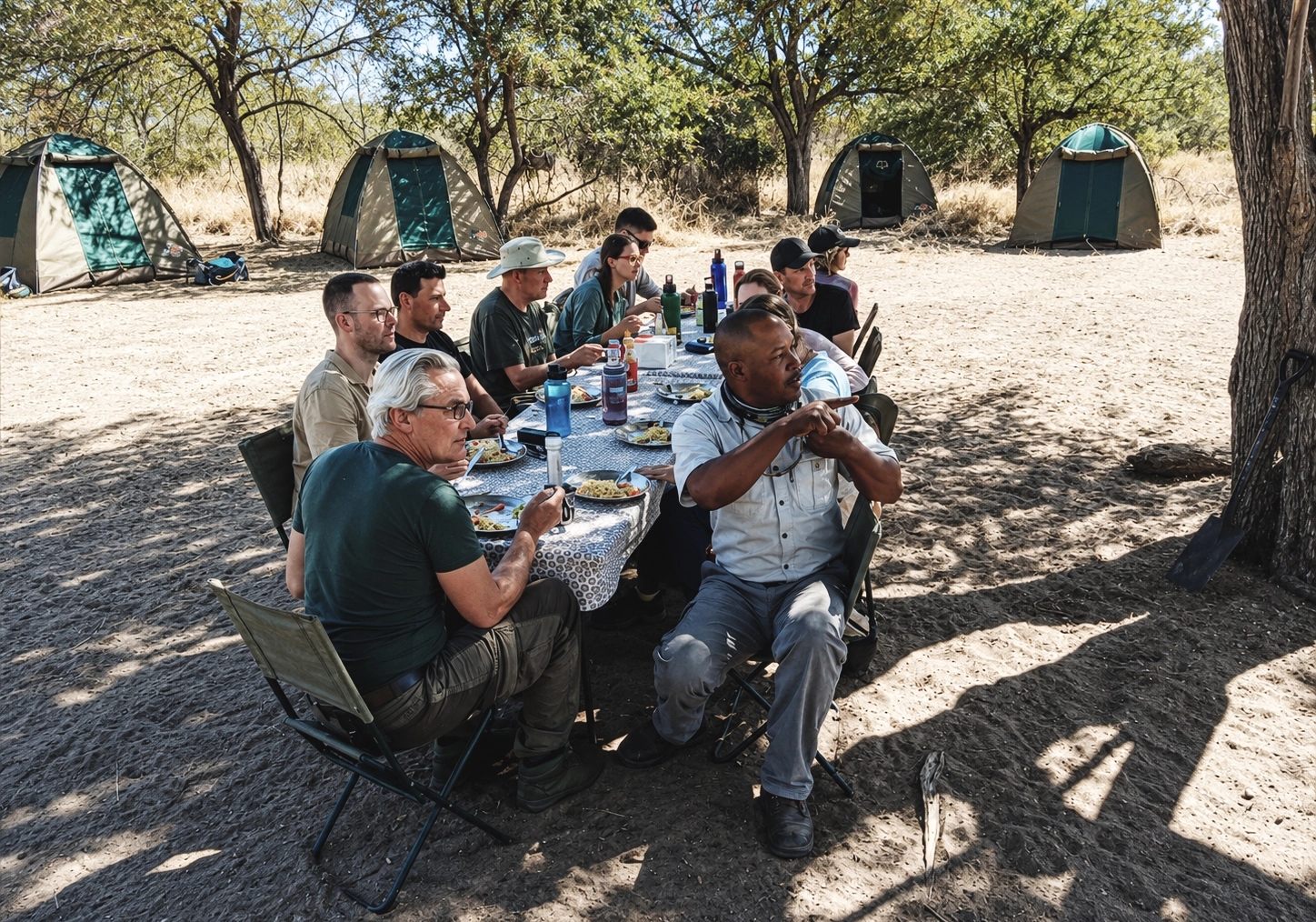 Group of travelers enjoying an outdoor lunch during a safari with Okavango Exploration Safaris in the Okavango Delta, Botswana